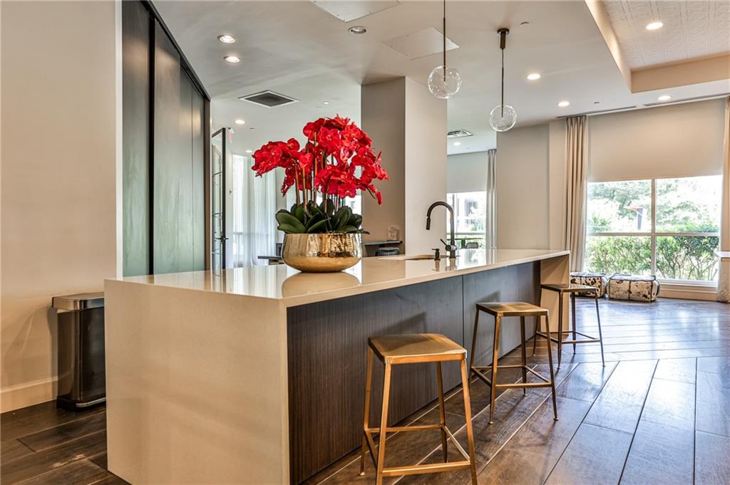 325 East Paces Ferry Road Northeast, Unit 1105 Atlanta, GA 30305 - Photo 26 of 36 a kitchen with granite countertop a table chairs and a window