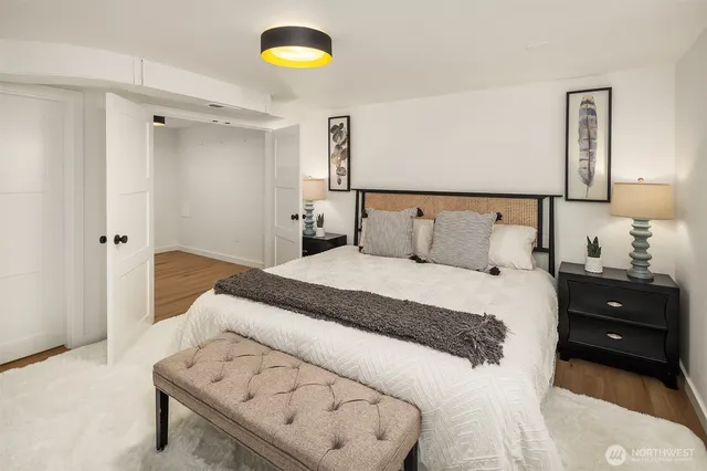 a bedroom with a bed and a lamp