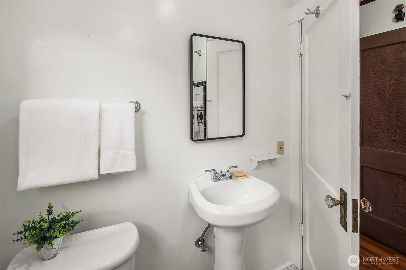 349 North 72nd Street Seattle, WA 98103 - Photo 21 of 26 a bathroom with a sink toilet and mirror