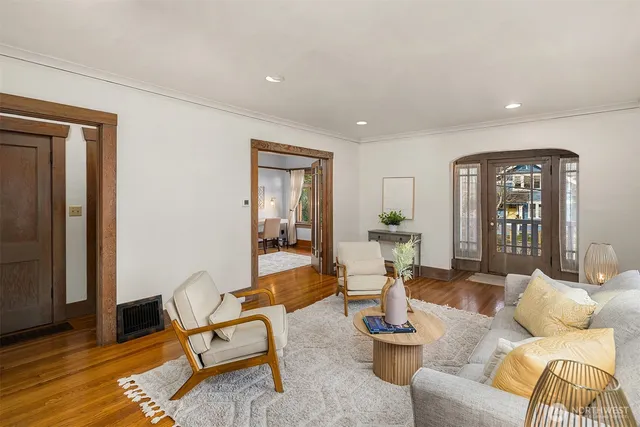 a living room with furniture and wooden floor