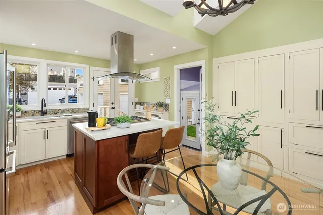 a kitchen with a table chairs stove and cabinets
