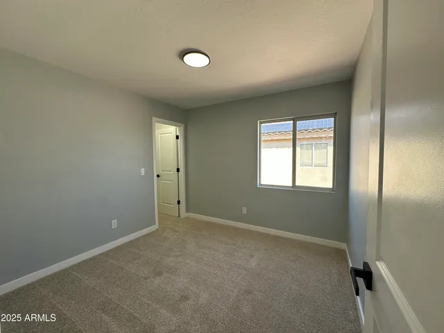 a room with windows and ceiling fan