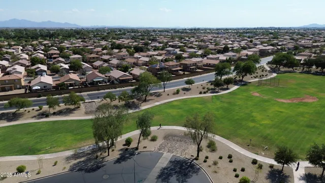 an aerial view of a house with a yard