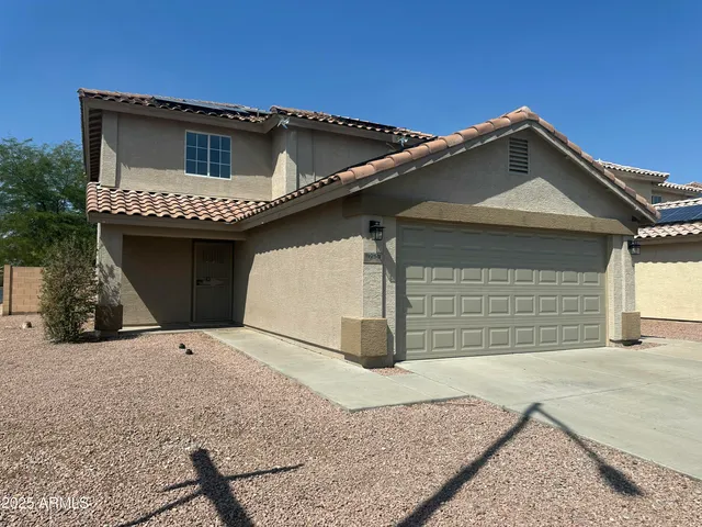 a front view of a house with a garage
