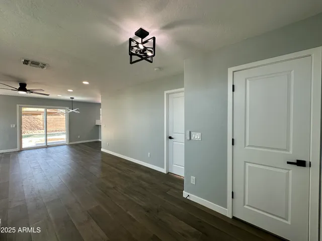 a view of entryway and hall with wooden floor