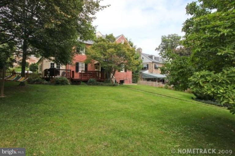 221 Tunbridge Road Baltimore, MD 21212 - Photo 5 of 14 a front view of a house with a garden and trees