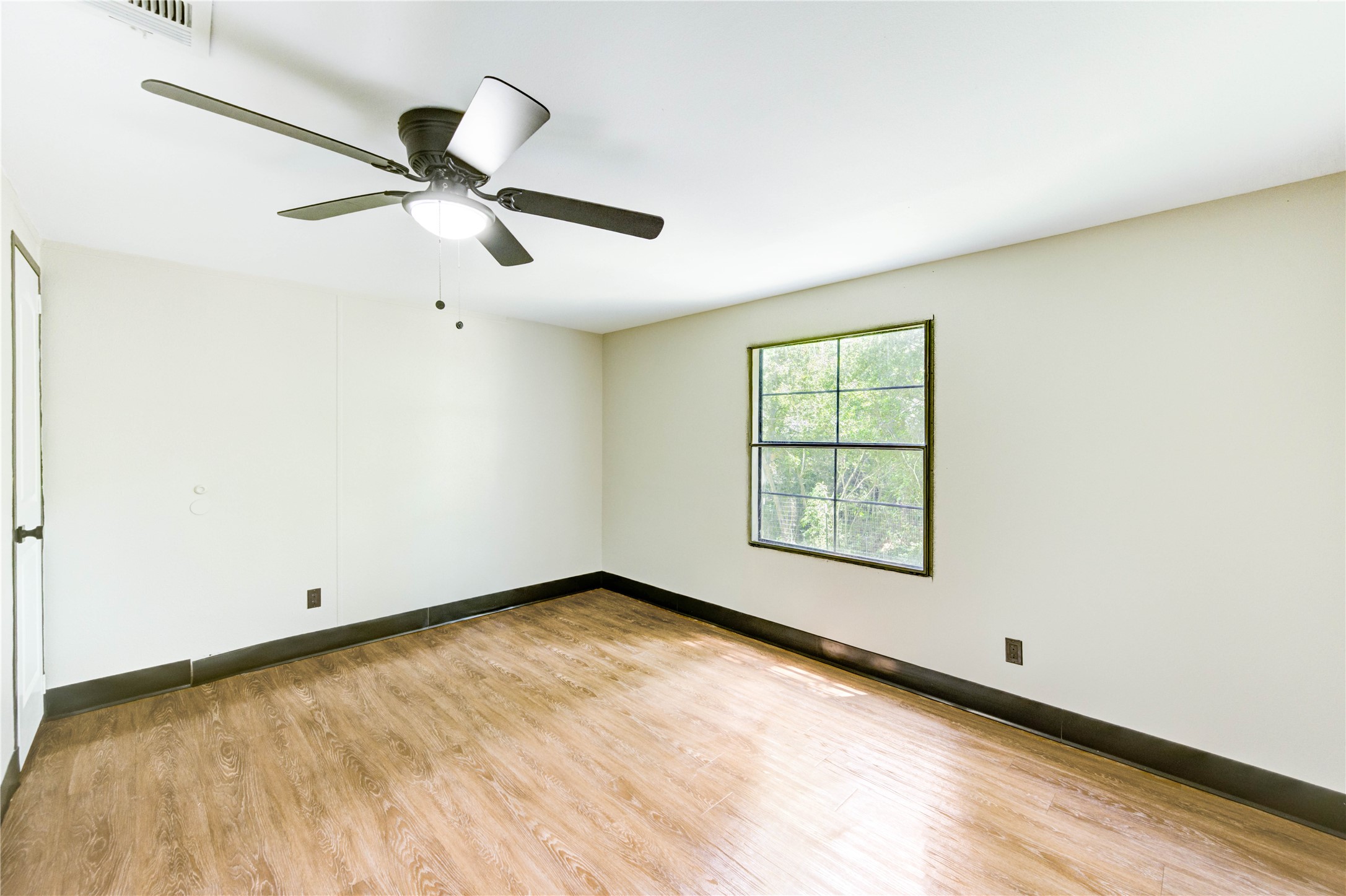 26342 Hunters Trail New Caney, TX 77357 - Photo 15 of 25 wooden floor in an empty room with a window