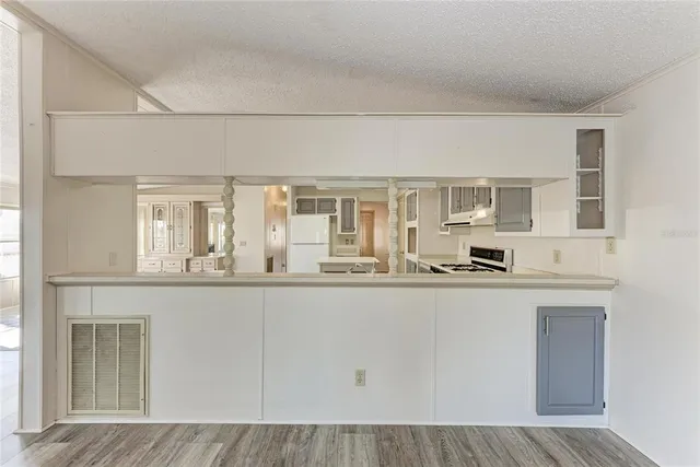 a kitchen with a refrigerator a sink and cabinets