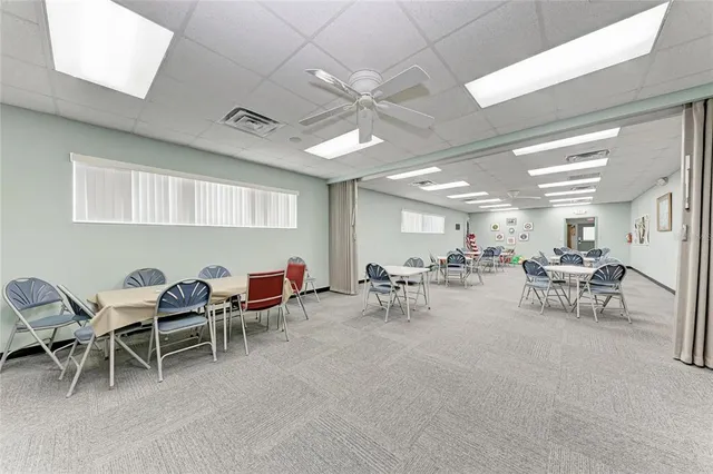 a view of a patio with table and chairs and wooden floor