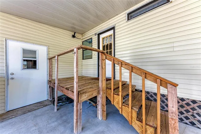 a view of outdoor space with wooden floor and stairs