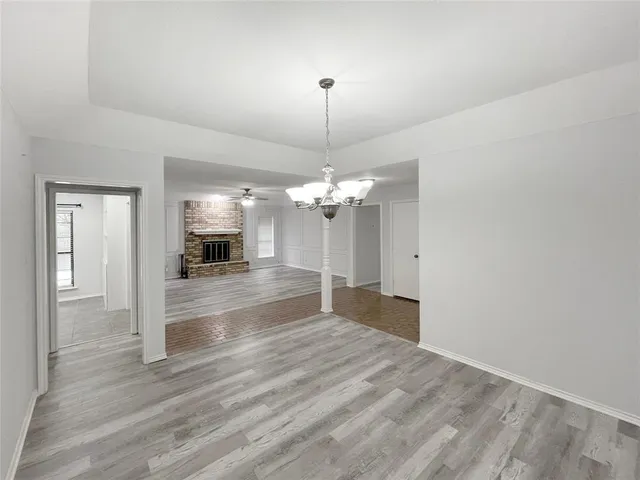 a view of a livingroom with wooden floor and a ceiling fan