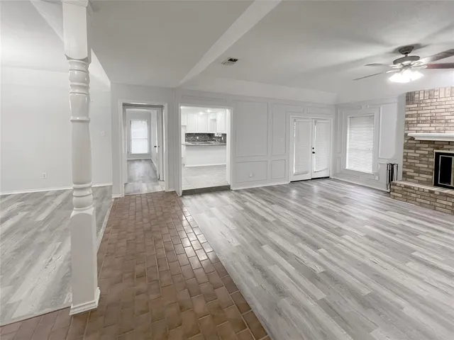 a living room with a fireplace and a floor to ceiling window