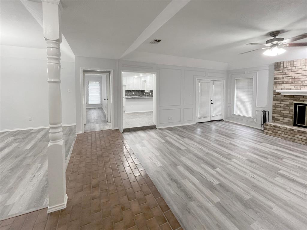 7716 Harmony Drive Fort Worth, TX 76133 - Photo 13 of 40 a view of a livingroom with wooden floor and a ceiling fan