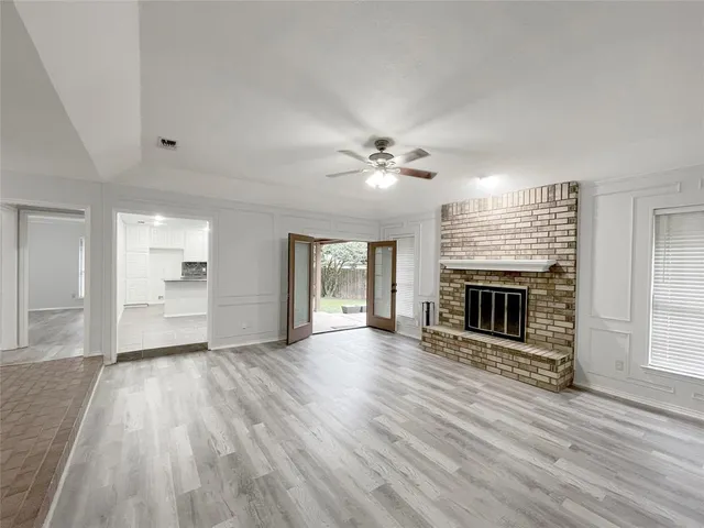 wooden floor in an empty room with a fireplace