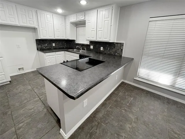 an empty room with a empty space and windows