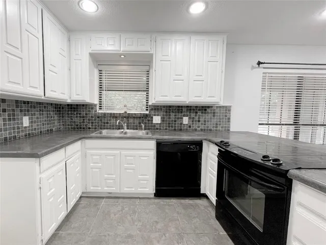 a spacious bathroom with a sink and a mirror
