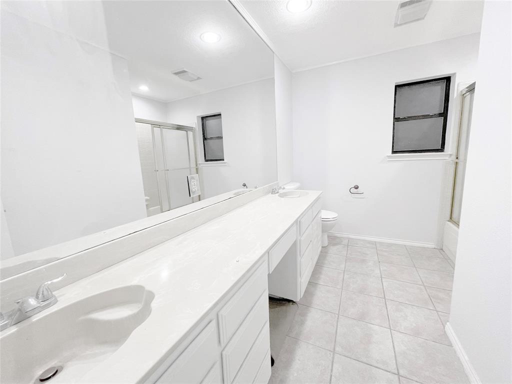 7716 Harmony Drive Fort Worth, TX 76133 - Photo 23 of 40 a spacious bathroom with a sink and a mirror