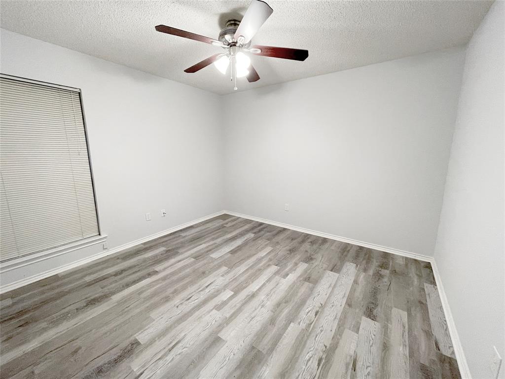 7716 Harmony Drive Fort Worth, TX 76133 - Photo 24 of 40 a view of empty room with wooden floor