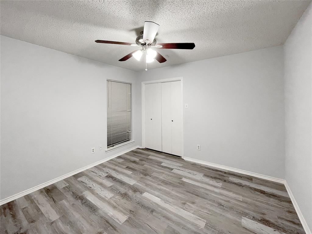 7716 Harmony Drive Fort Worth, TX 76133 - Photo 26 of 40 a view of an empty room with wooden floor