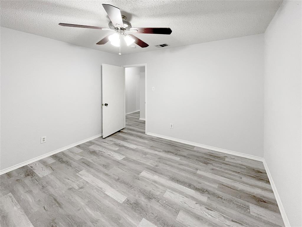 7716 Harmony Drive Fort Worth, TX 76133 - Photo 27 of 40 wooden floor in an empty room