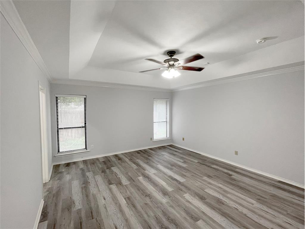 7716 Harmony Drive Fort Worth, TX 76133 - Photo 31 of 40 wooden floor in an empty room with a window