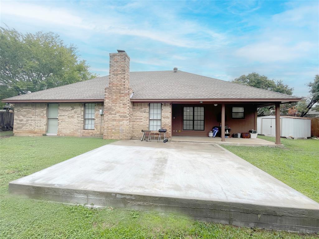 7716 Harmony Drive Fort Worth, TX 76133 - Photo 37 of 40 a front view of a house with a garden and yard