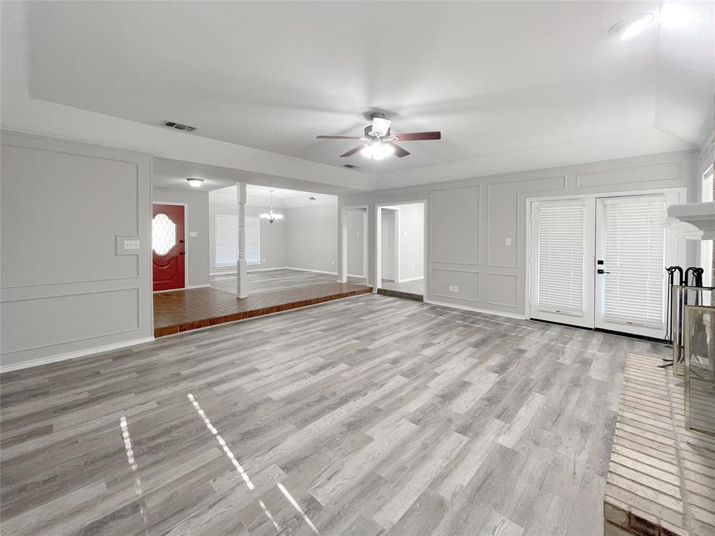 7716 Harmony Drive Fort Worth, TX 76133 - Photo 4 of 40 a view of an empty room with window and a ceiling fan