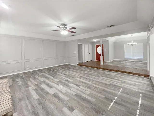 a view of a room with window wooden floor and door