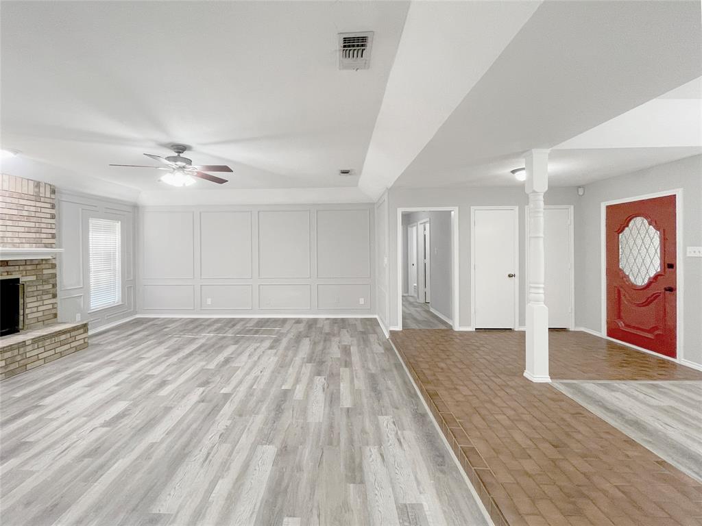 7716 Harmony Drive Fort Worth, TX 76133 - Photo 10 of 40 a view of an empty room with window and wooden floor