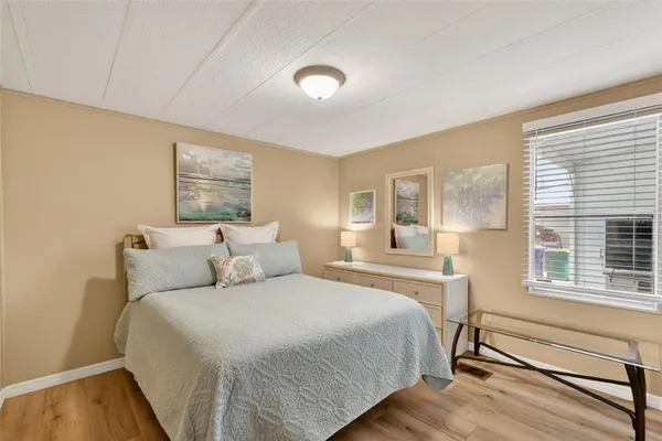 a bedroom with a bed and a large window