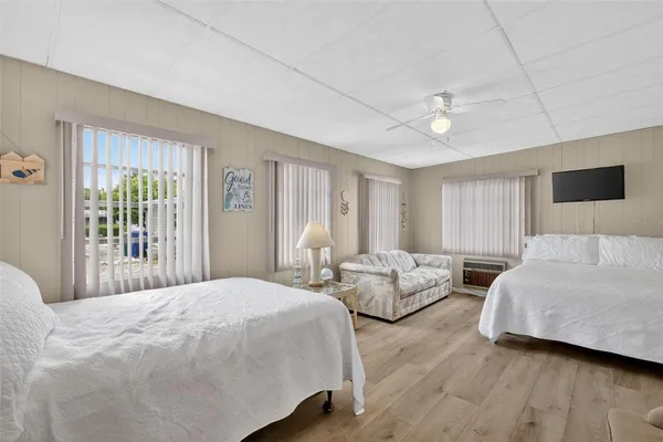 a bedroom with two beds and a large window