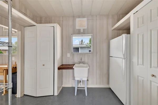 a room with a refrigerator and a table