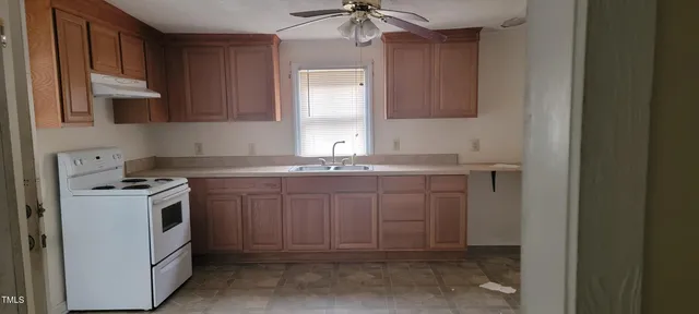a kitchen with a sink stove and cabinets