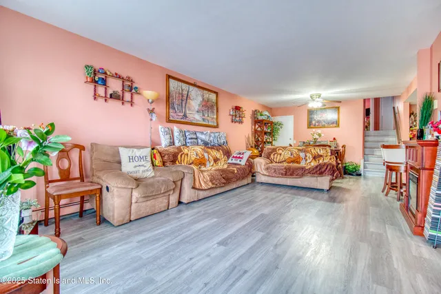 a bedroom with furniture and a wooden floor