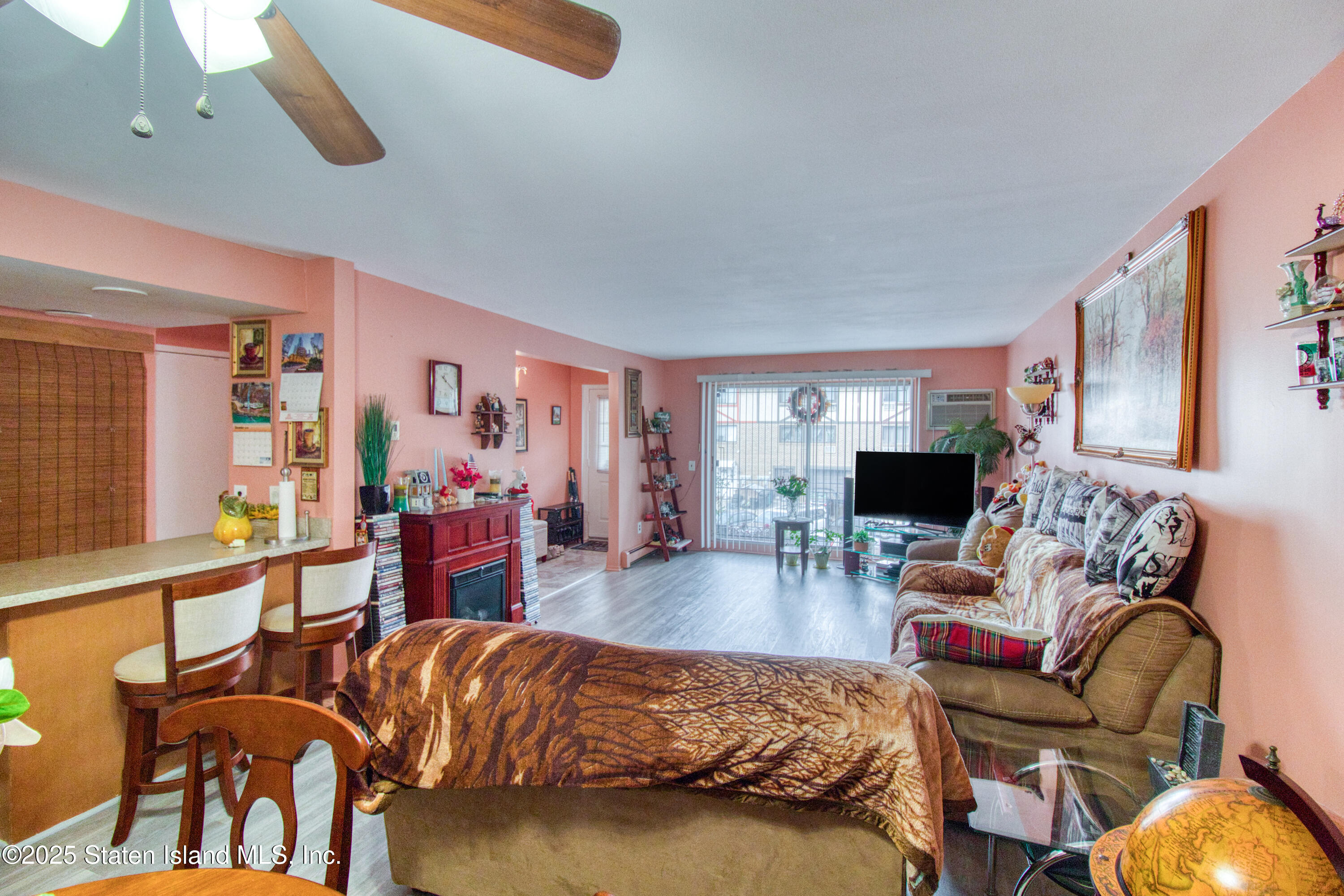 52 Racal Court, Unit A2 Staten Island, NY 10314 - Photo 12 of 28 a living room with furniture and a flat screen tv