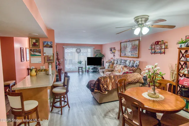 a living room with furniture a chandelier and a flat screen tv