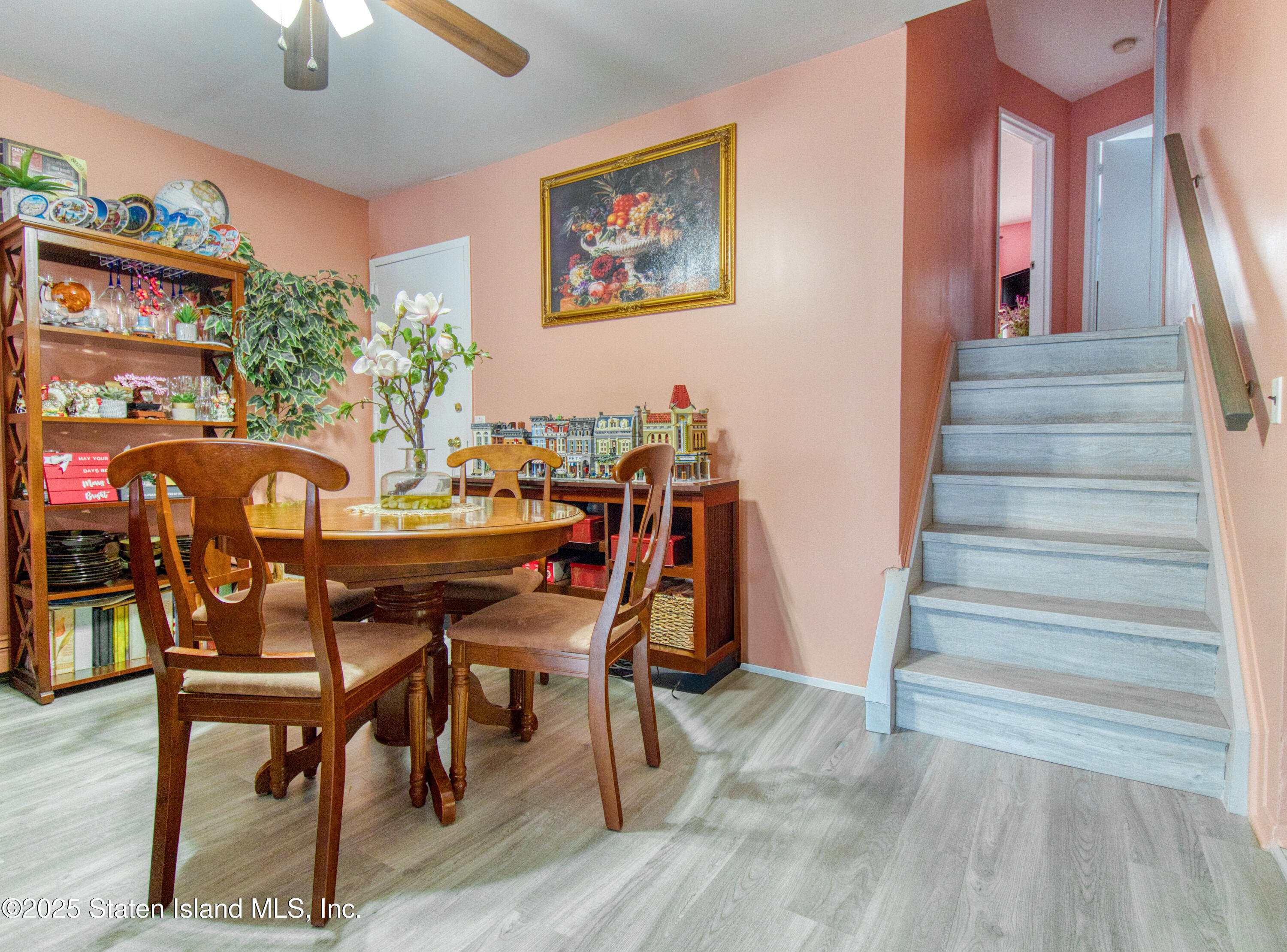 52 Racal Court, Unit A2 Staten Island, NY 10314 - Photo 14 of 28 a view of a dining room with furniture and wooden floor