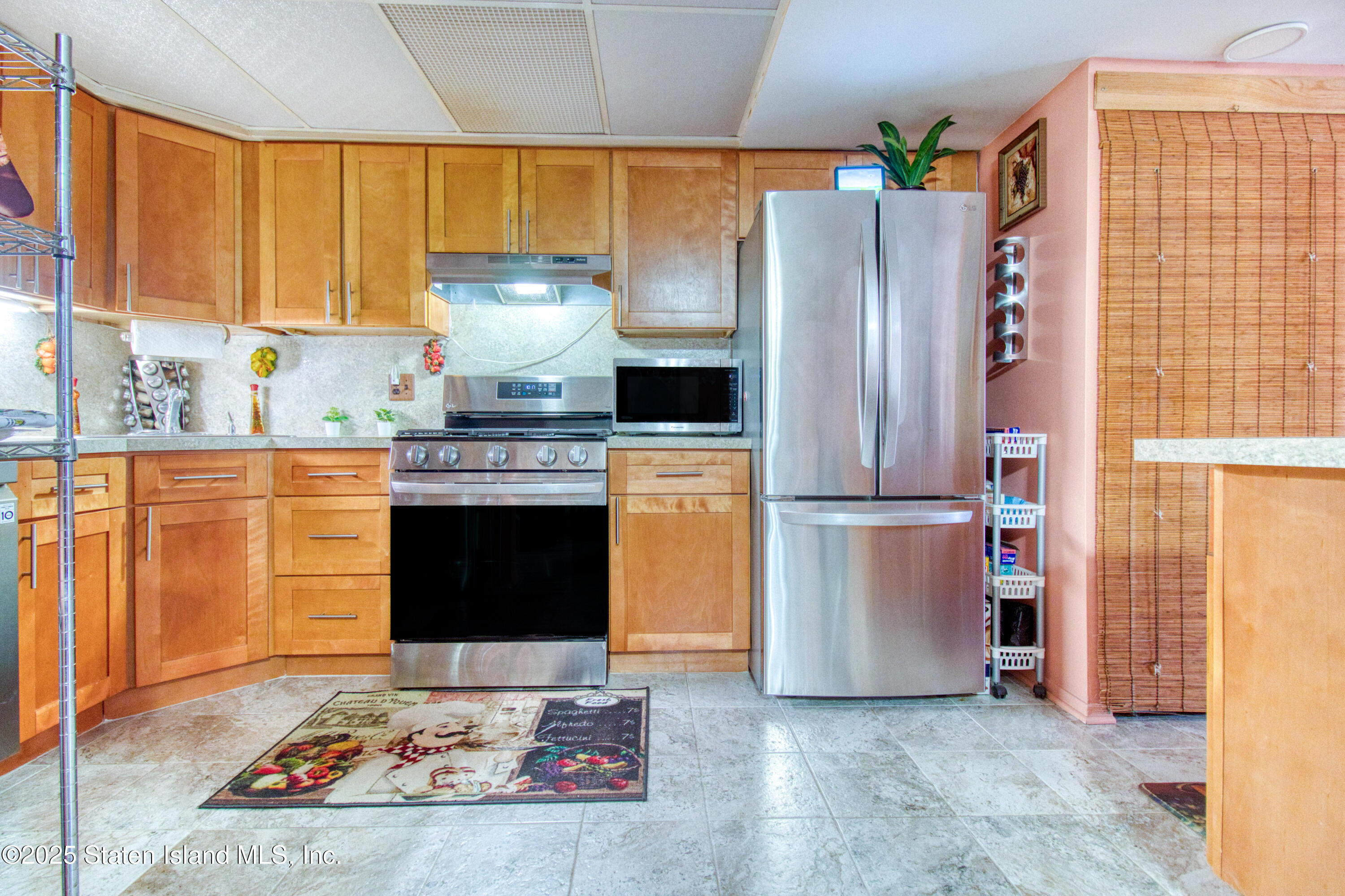 52 Racal Court, Unit A2 Staten Island, NY 10314 - Photo 15 of 28 a kitchen with stainless steel appliances granite countertop a refrigerator stove and sink