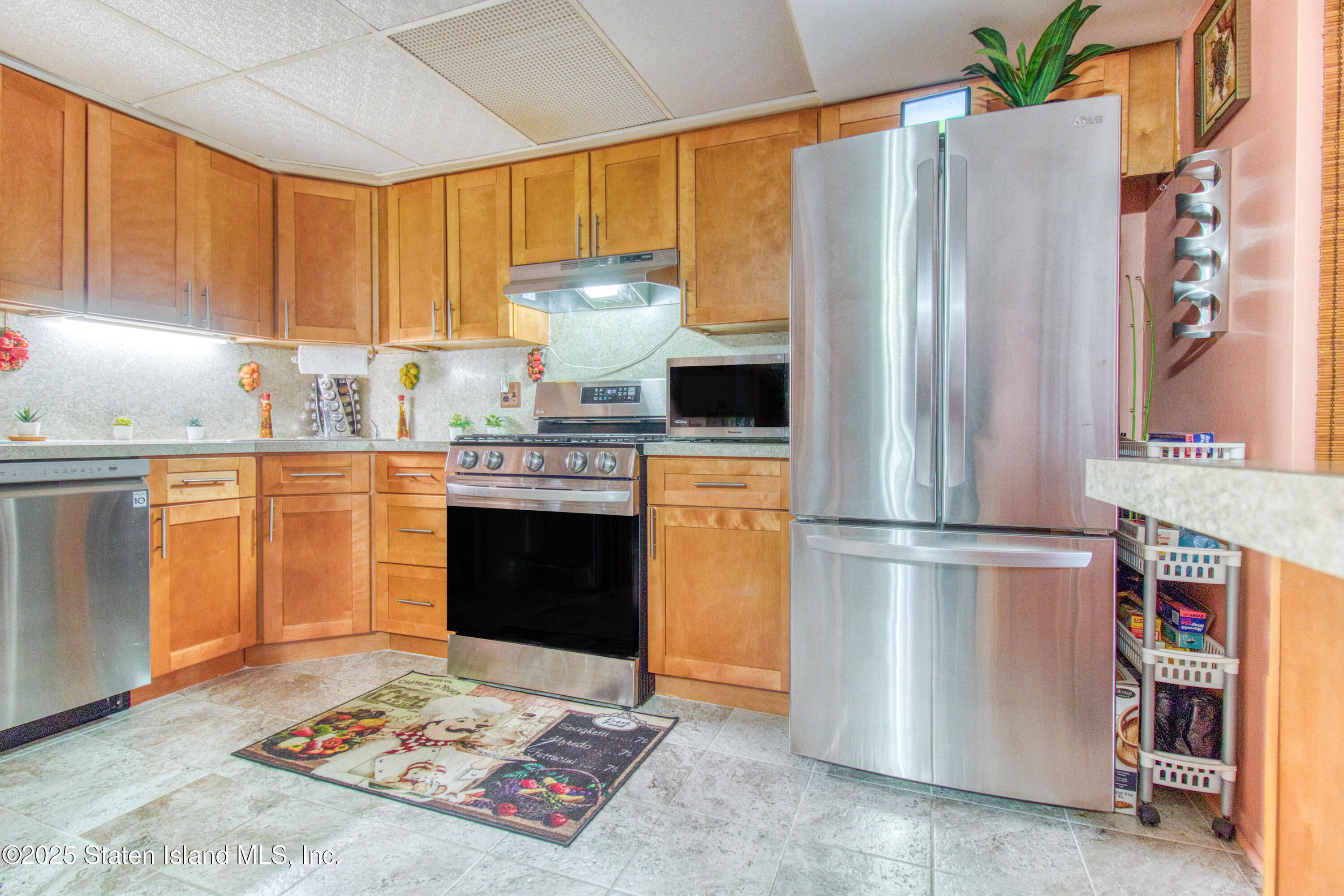 52 Racal Court, Unit A2 Staten Island, NY 10314 - Photo 16 of 28 a kitchen with stainless steel appliances granite countertop a refrigerator sink and cabinets