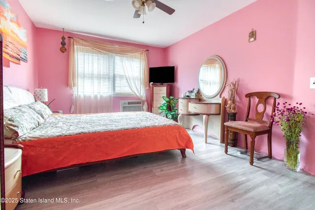 a bedroom with a bed chair and a large window