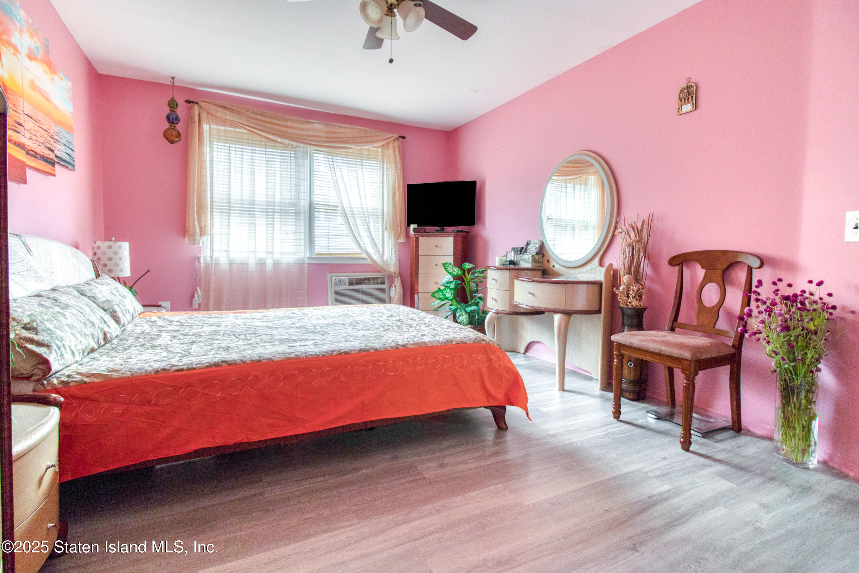 52 Racal Court, Unit A2 Staten Island, NY 10314 - Photo 20 of 28 a bedroom with a bed chair and a large window