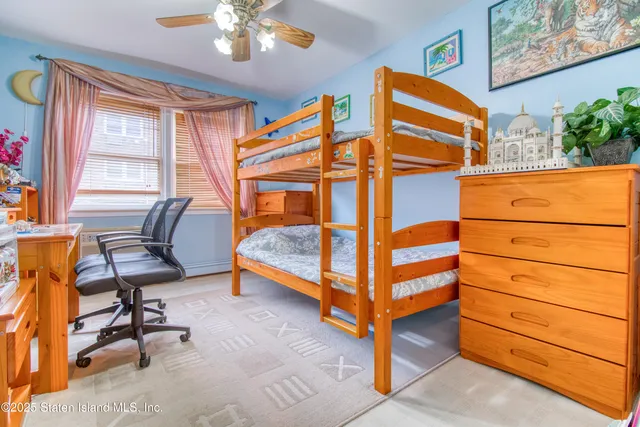 a bedroom with a bed and a dresser in it