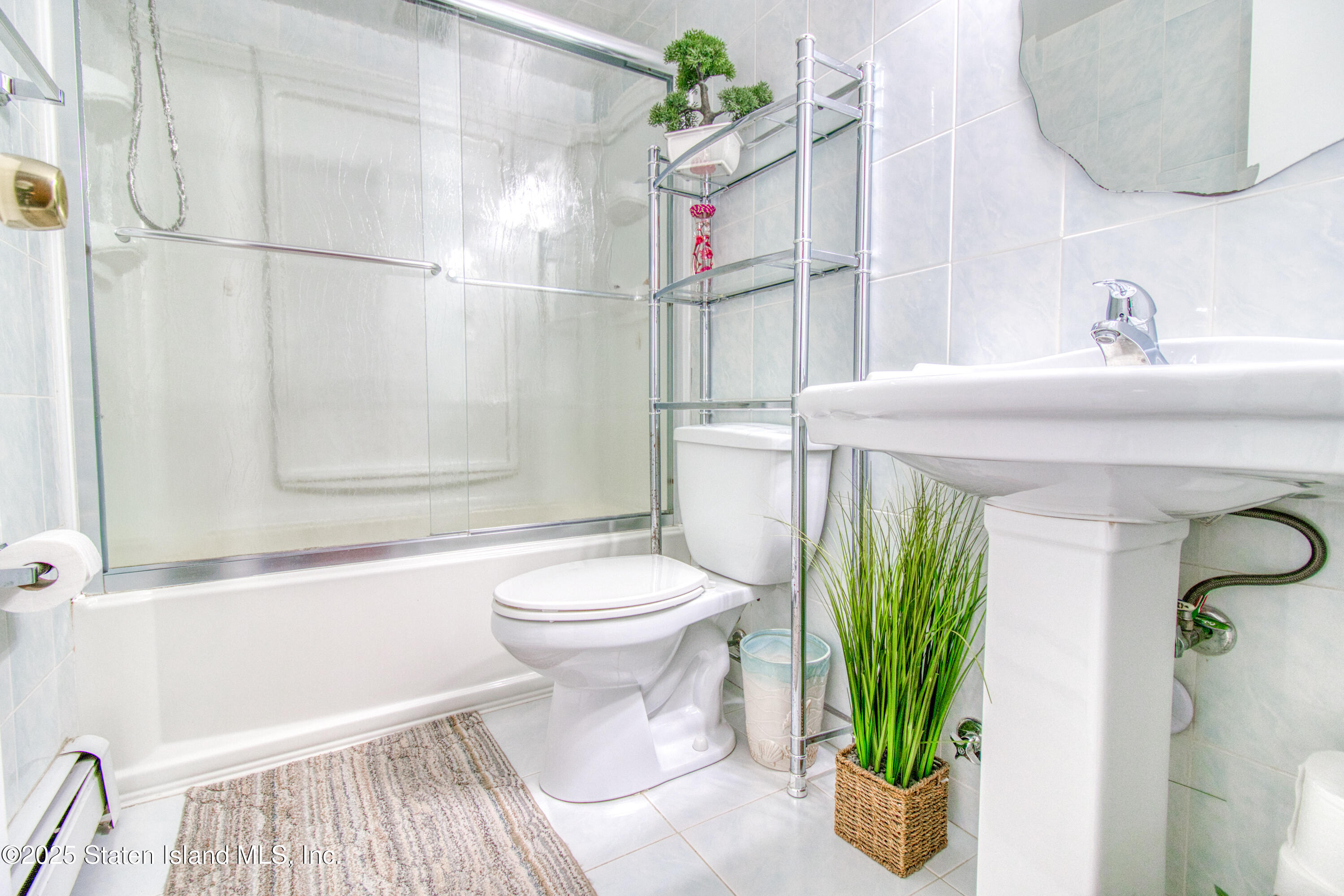 52 Racal Court, Unit A2 Staten Island, NY 10314 - Photo 23 of 28 a bathroom with a sink a toilet and shower