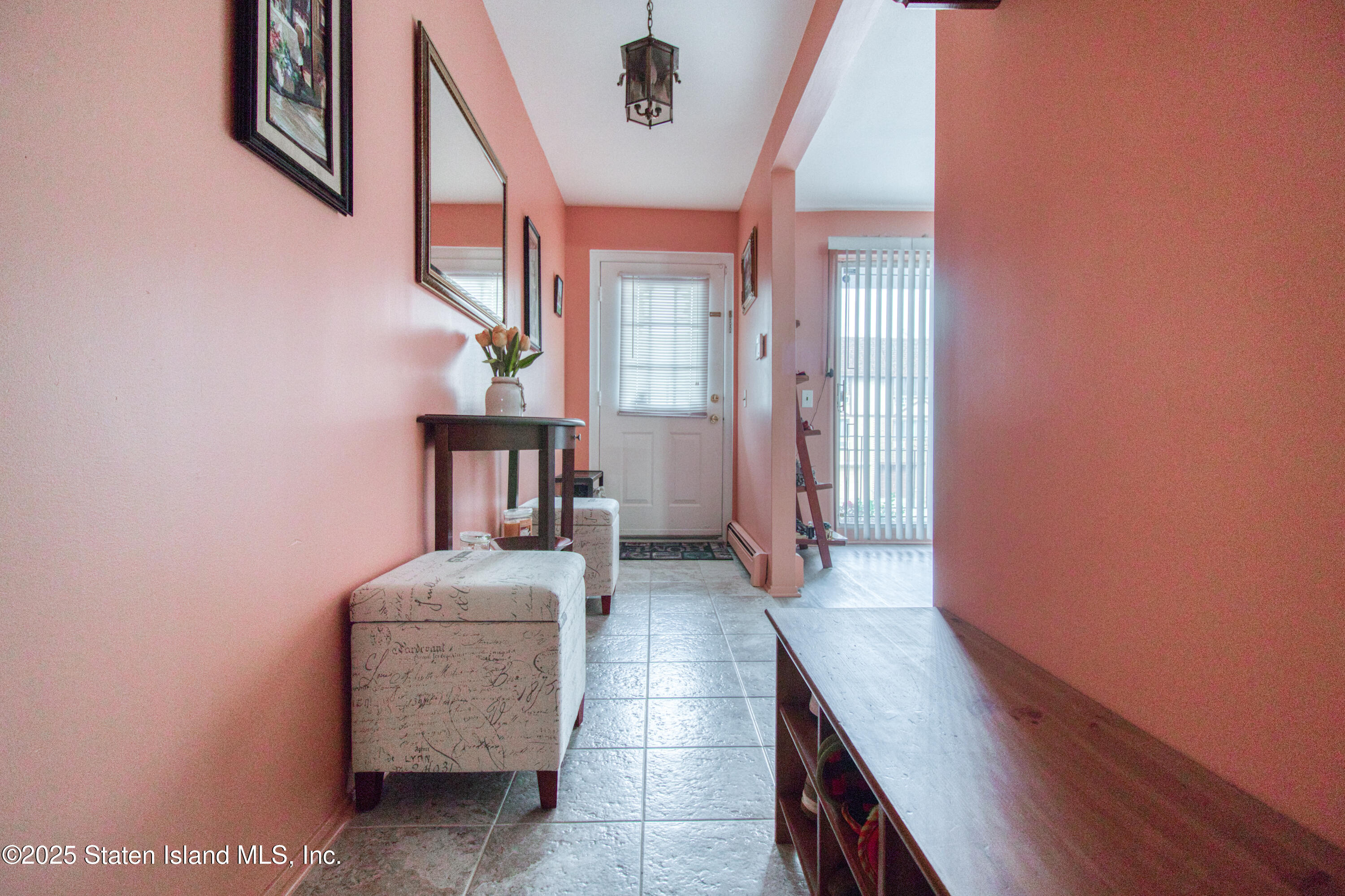 52 Racal Court, Unit A2 Staten Island, NY 10314 - Photo 5 of 28 a hallway with a wooden floor and entryway