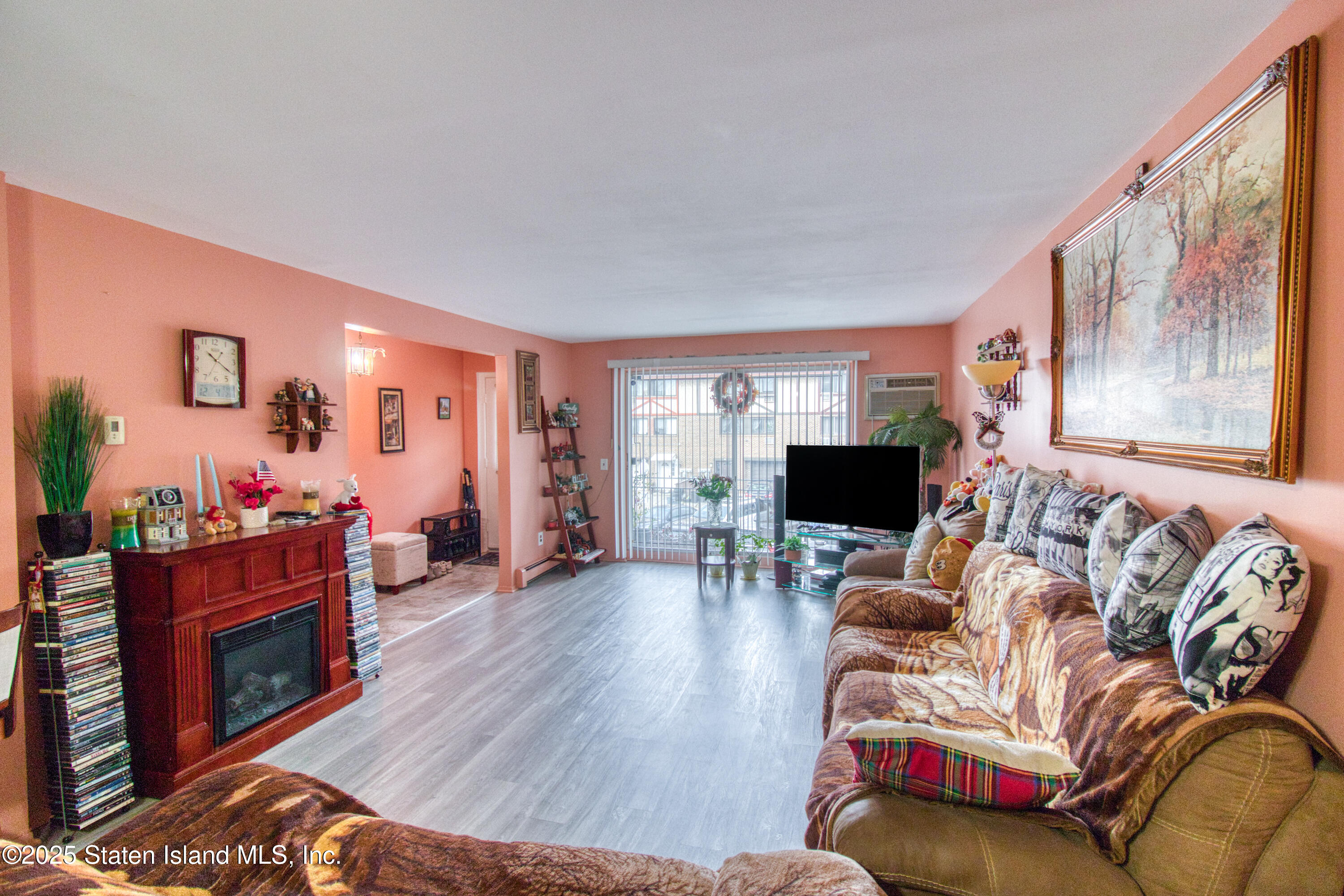 52 Racal Court, Unit A2 Staten Island, NY 10314 - Photo 7 of 28 a living room with furniture and a flat screen tv