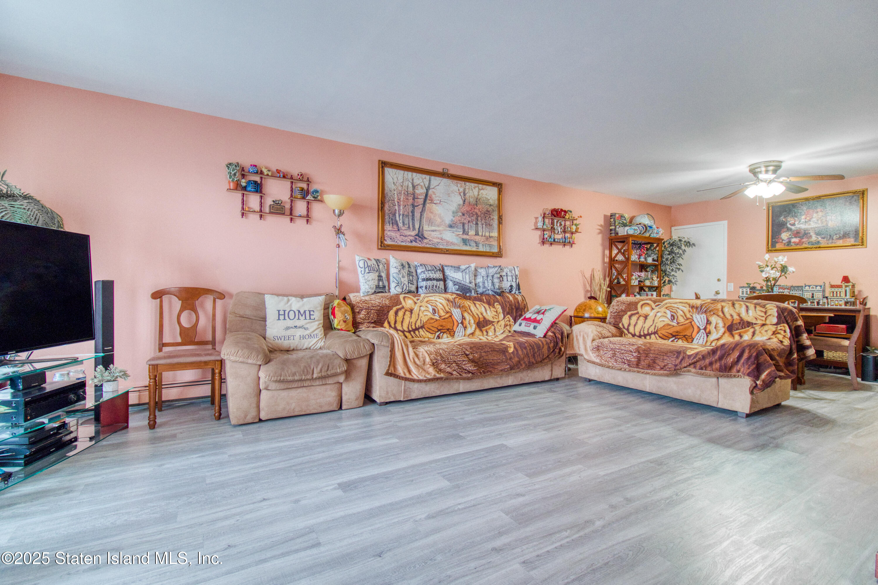 52 Racal Court, Unit A2 Staten Island, NY 10314 - Photo 10 of 28 a bedroom with furniture and a flat screen tv