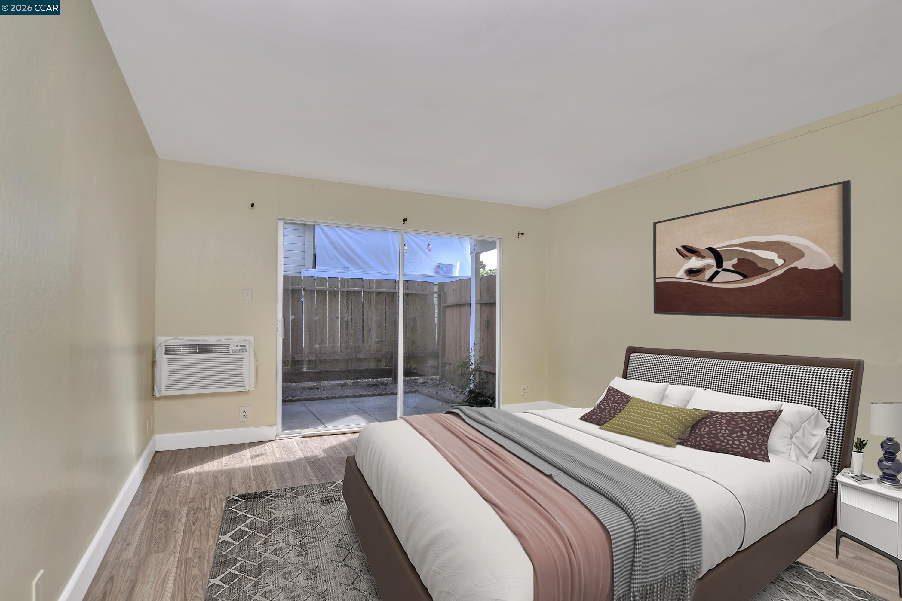 4888 Clayton Road, Unit 6 Concord, CA 94521 - Photo 13 of 16 a bedroom with a bed and a painting on the wall