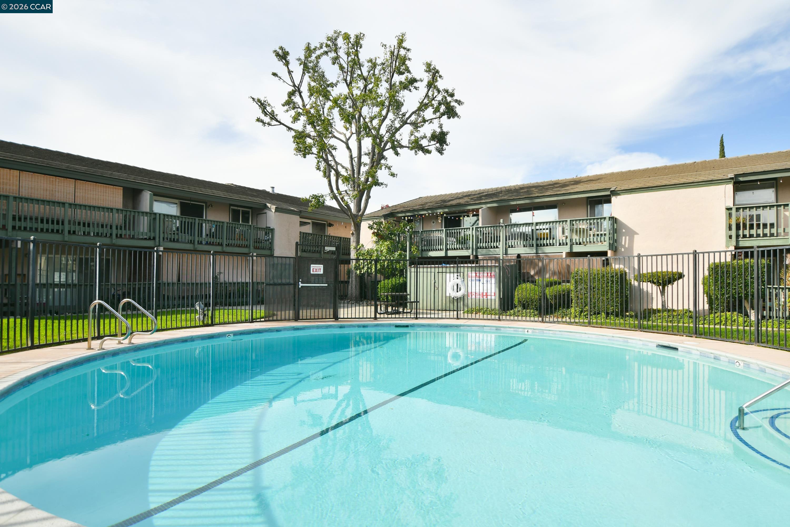 4888 Clayton Road, Unit 6 Concord, CA 94521 - Photo 15 of 16 a view of a building with a swimming pool