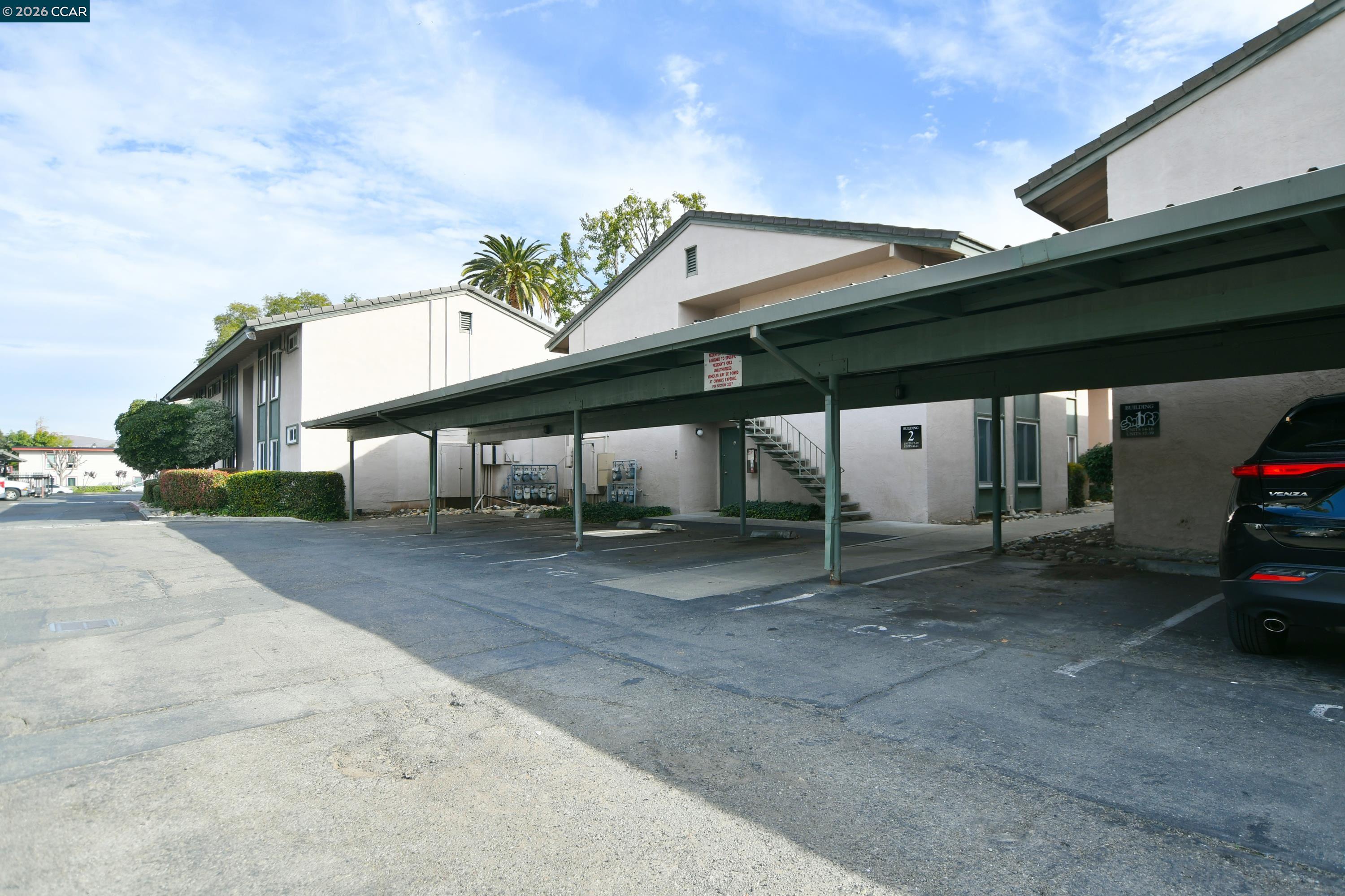 4888 Clayton Road, Unit 6 Concord, CA 94521 - Photo 16 of 16 a view of a house with a yard and garage