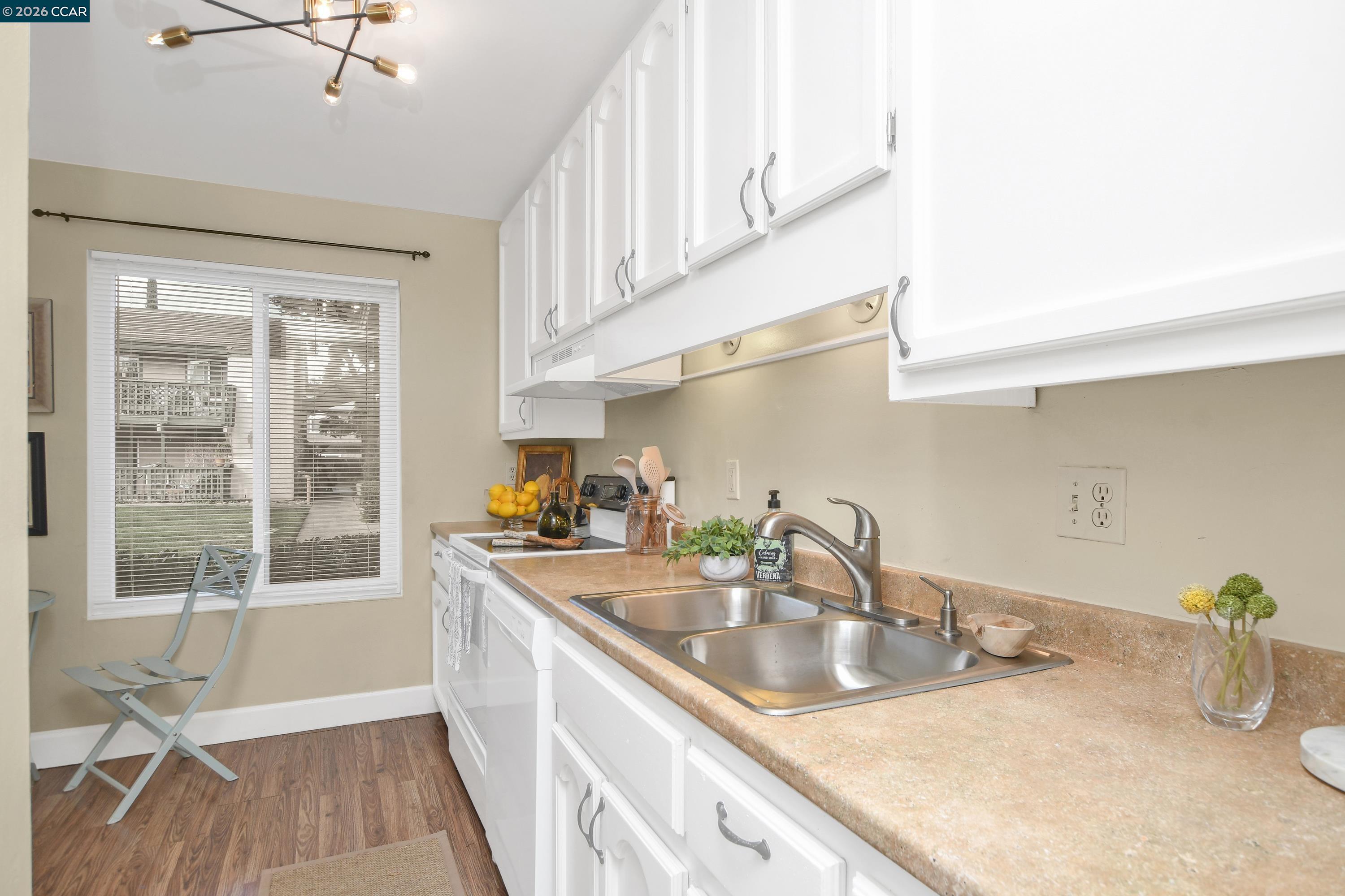 4888 Clayton Road, Unit 6 Concord, CA 94521 - Photo 10 of 16 a kitchen with stainless steel appliances a sink a stove and a window